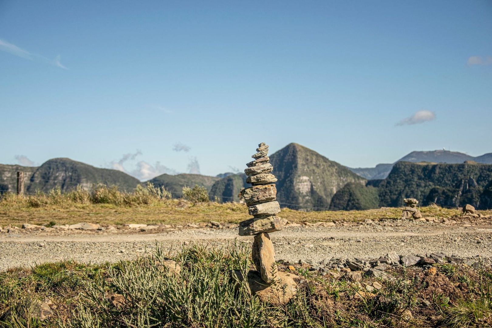 Cairn de pierres au premier plan devant un paysage montagneux